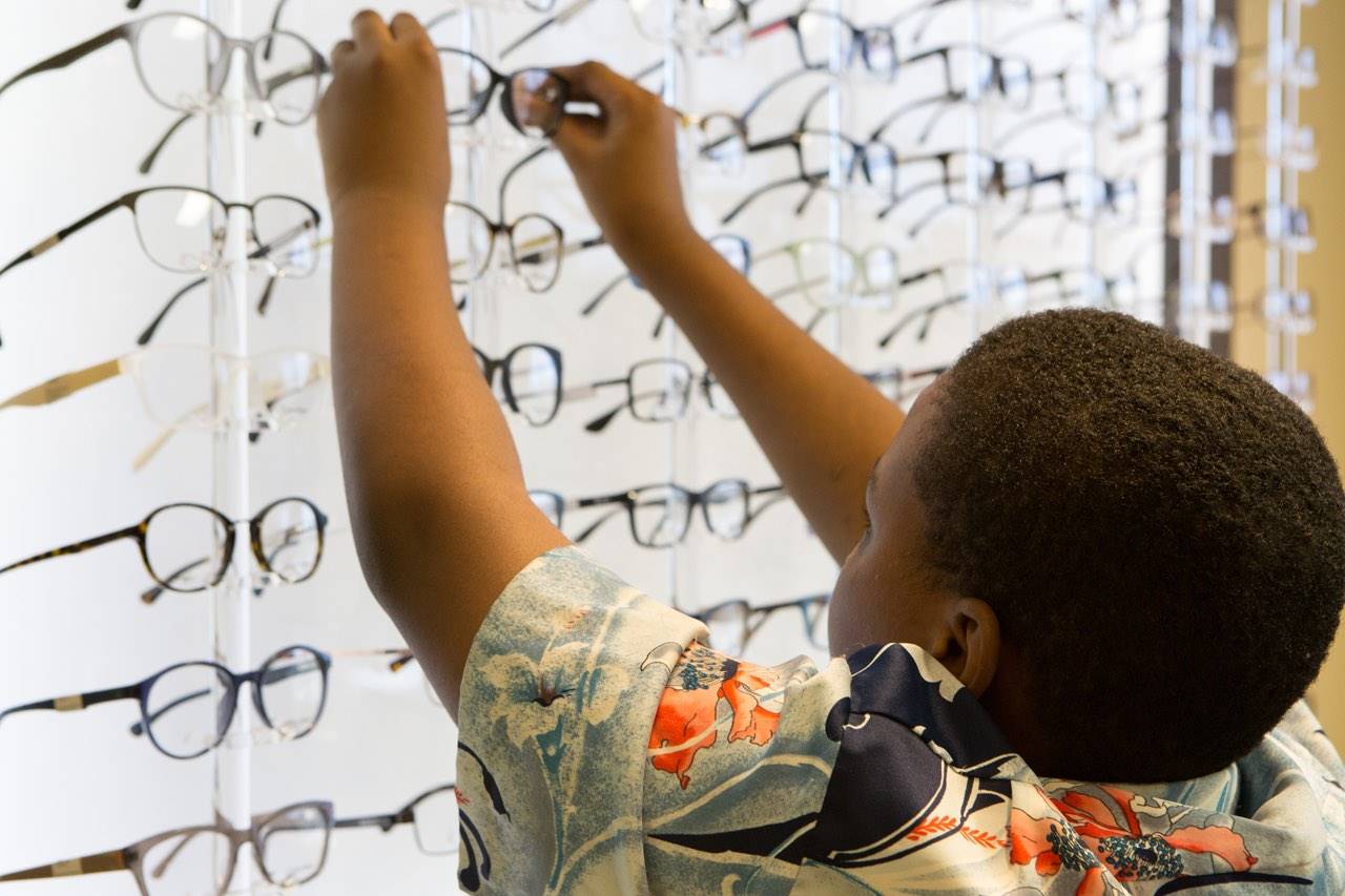 child reach for eyeglasses after eye exam on katy, tx